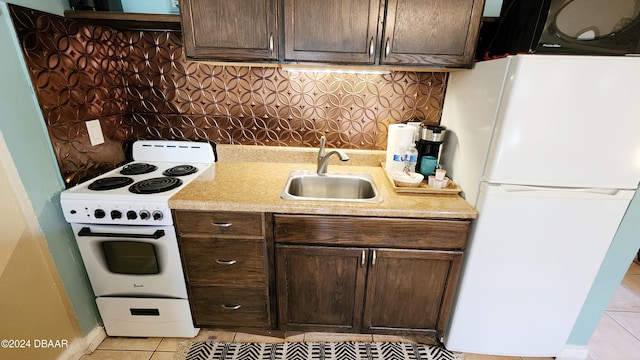 kitchen with white appliances, sink, dark brown cabinetry, and light tile patterned floors