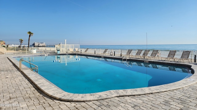 view of pool with a water view