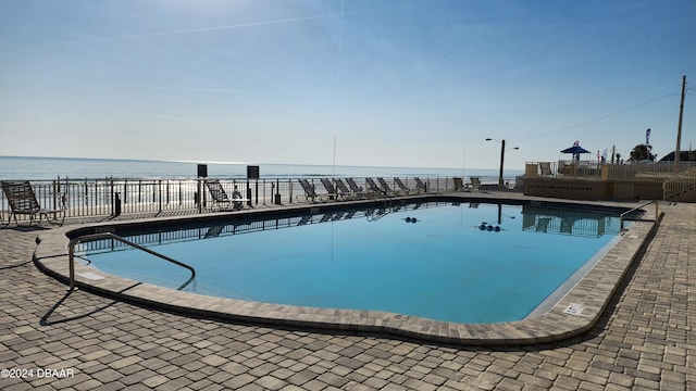 view of pool with a water view