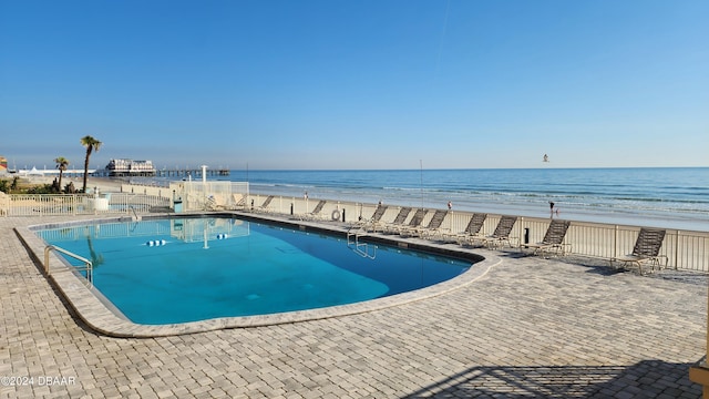 219 S Atlantic Ave Unit 135, Daytona Beach, FL 32118 - community pool with a water view, a patio, and fence