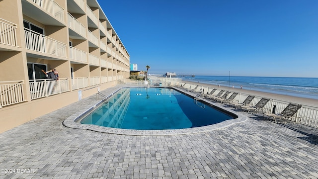 219 S Atlantic Ave Unit 135, Daytona Beach, FL 32118 - community pool with view of water and beach and a patio area