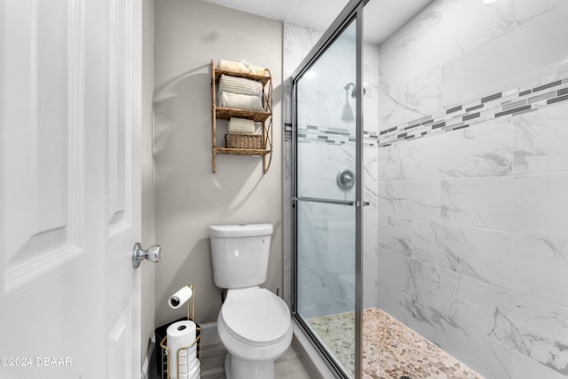 bathroom featuring walk in shower and toilet