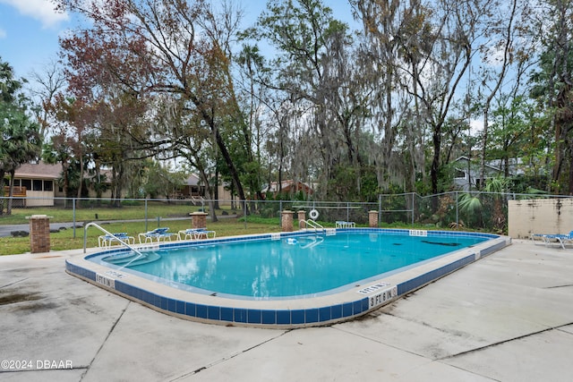 view of pool with a yard and a patio area