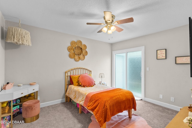 carpeted bedroom featuring a textured ceiling and ceiling fan