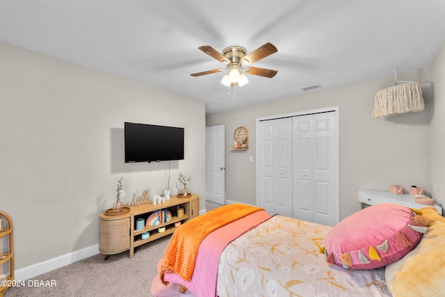 carpeted bedroom featuring a closet and ceiling fan