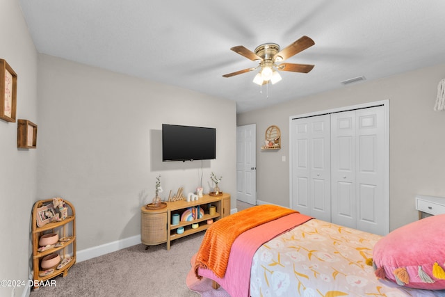 bedroom with ceiling fan, a closet, and light colored carpet