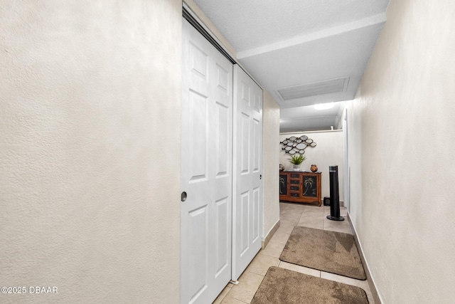 hallway with light tile patterned floors