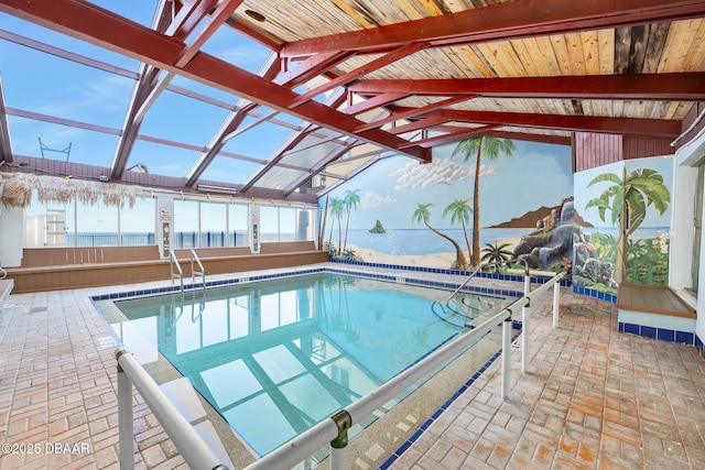 view of pool with a water view and a patio