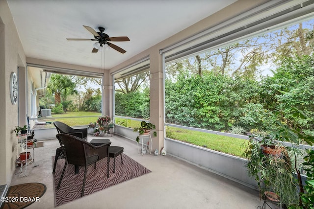 sunroom / solarium with a ceiling fan