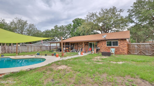 back of property featuring brick siding and a patio area