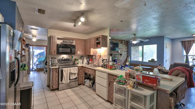 kitchen featuring appliances with stainless steel finishes, ceiling fan, a peninsula, and light tile patterned floors