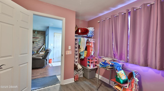 recreation room featuring wood finished floors and baseboards