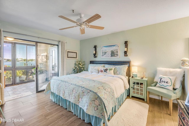 456 Bouchelle Dr Unit 104, New Smyrna Beach, FL 32169 - bedroom with access to exterior, wood finished floors, and ceiling fan