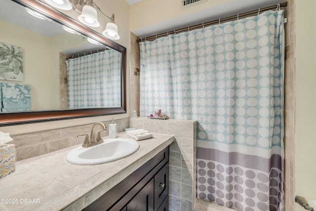 456 Bouchelle Dr Unit 104, New Smyrna Beach, FL 32169 - bathroom with vanity, curtained shower, and visible vents