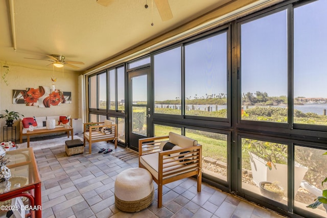 456 Bouchelle Dr Unit 104, New Smyrna Beach, FL 32169 - sunroom with plenty of natural light, a ceiling fan, and a water view