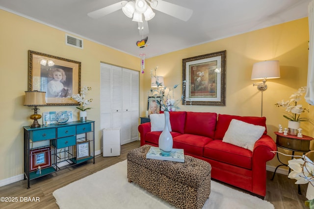 456 Bouchelle Dr Unit 104, New Smyrna Beach, FL 32169 - living room featuring visible vents, baseboards, a ceiling fan, and wood finished floors