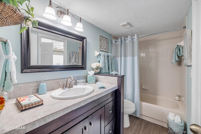 456 Bouchelle Dr Unit 104, New Smyrna Beach, FL 32169 - full bath featuring vanity, wood finished floors, shower / bath combination with curtain, a textured ceiling, and toilet