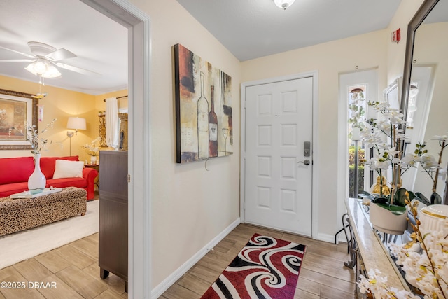 456 Bouchelle Dr Unit 104, New Smyrna Beach, FL 32169 - foyer with baseboards, light wood-type flooring, and ceiling fan
