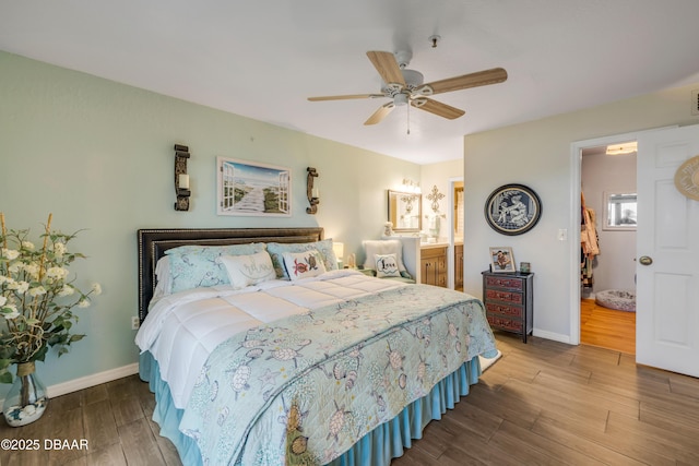 456 Bouchelle Dr Unit 104, New Smyrna Beach, FL 32169 - bedroom with ceiling fan, connected bathroom, baseboards, and wood finished floors