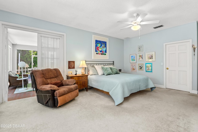 carpeted bedroom with visible vents, baseboards, ceiling fan, and access to exterior