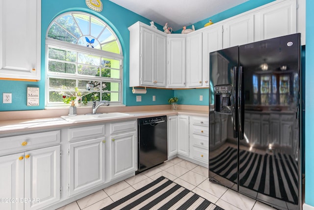 kitchen with white cabinetry, black appliances, and light countertops