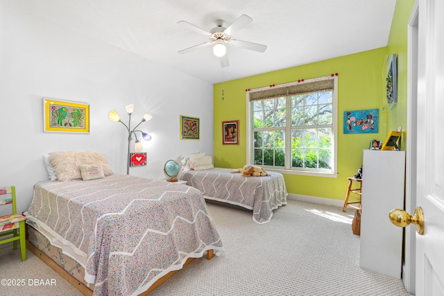 carpeted bedroom with baseboards and ceiling fan