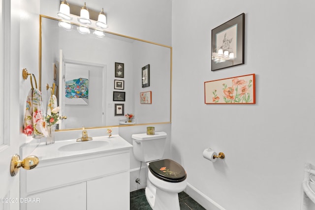 bathroom with baseboards, toilet, vanity, and tile patterned flooring