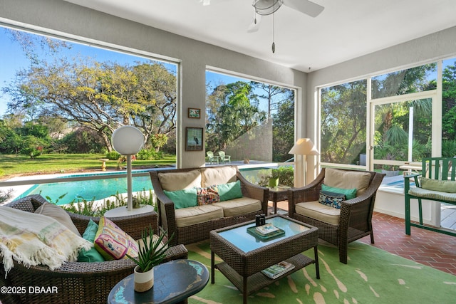 sunroom / solarium with a ceiling fan