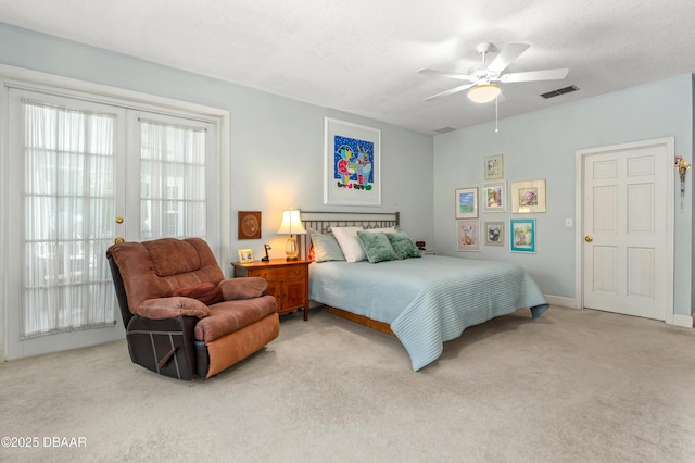 carpeted bedroom featuring a ceiling fan, baseboards, visible vents, french doors, and a textured ceiling