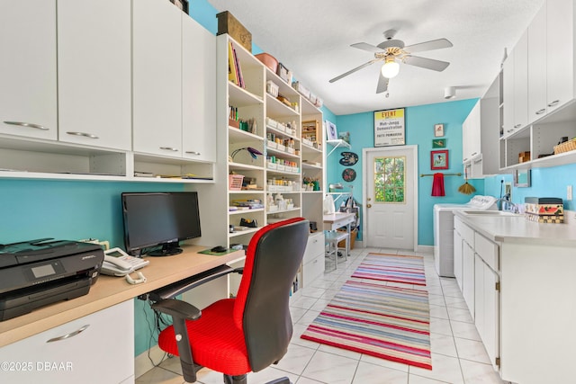 office area with a textured ceiling, light tile patterned floors, washing machine and dryer, and ceiling fan