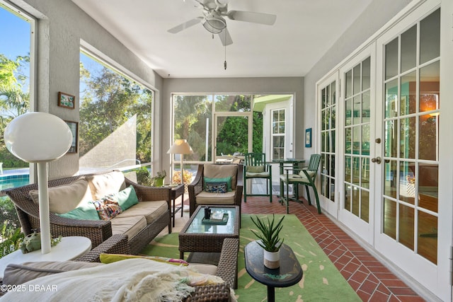 sunroom featuring french doors and ceiling fan