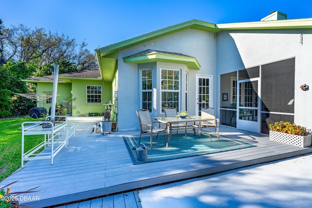 wooden deck featuring a sunroom