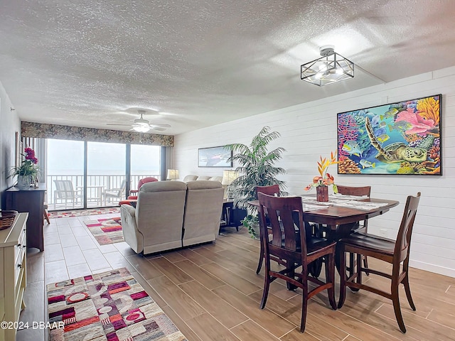 dining area with hardwood / wood-style floors and a textured ceiling