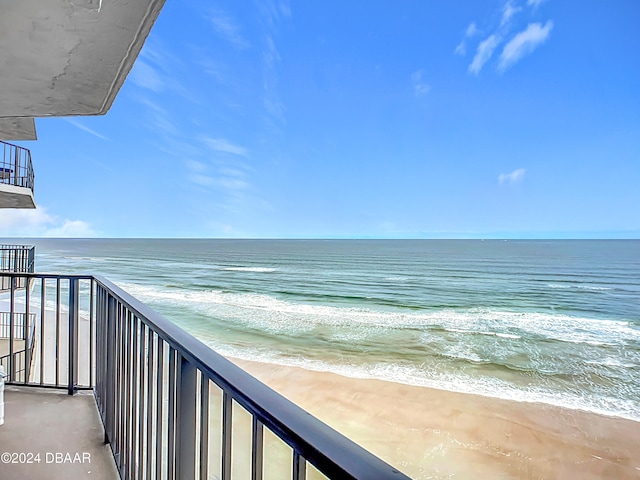 balcony with a water view and a beach view