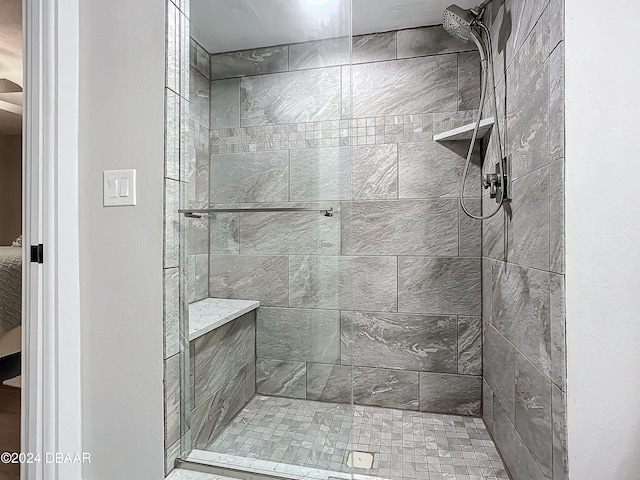 bathroom with a tile shower