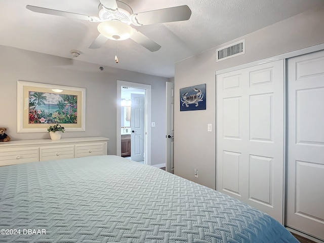 bedroom with ceiling fan, a closet, and a textured ceiling