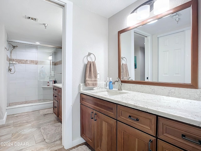 bathroom featuring vanity and an enclosed shower