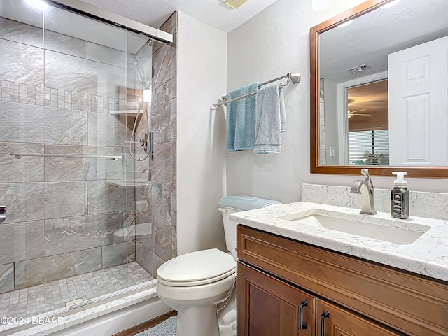 bathroom with vanity, toilet, and walk in shower