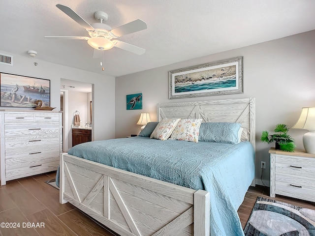 bedroom with a textured ceiling, ensuite bath, ceiling fan, and dark hardwood / wood-style floors