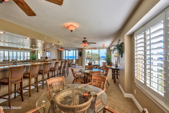 4631 S Atlantic Ave Unit 8101, Ponce Inlet, FL 32127 - dining space featuring light colored carpet, a ceiling fan, and baseboards