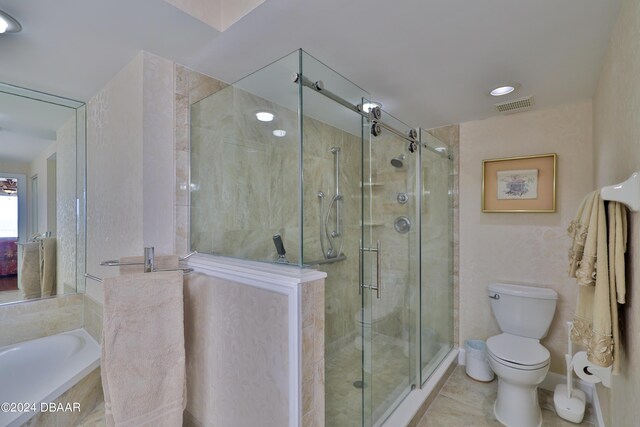 4631 S Atlantic Ave Unit 8101, Ponce Inlet, FL 32127 - bathroom featuring toilet, a shower stall, and a garden tub