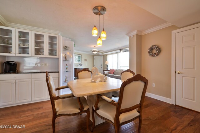 4631 S Atlantic Ave Unit 8101, Ponce Inlet, FL 32127 - dining space featuring crown molding, dark wood-style floors, ceiling fan, and baseboards