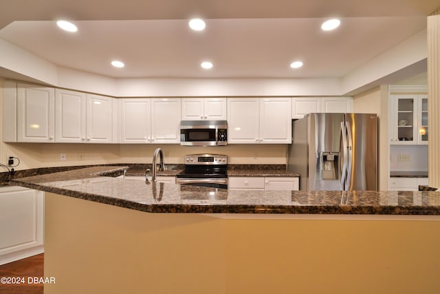 4631 S Atlantic Ave Unit 8101, Ponce Inlet, FL 32127 - kitchen featuring stainless steel appliances, white cabinetry, dark stone counters, a sink, and recessed lighting