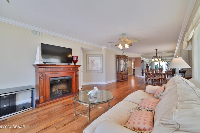 4631 S Atlantic Ave Unit 8101, Ponce Inlet, FL 32127 - living room featuring a chandelier, light wood-style flooring, ornamental molding, a glass covered fireplace, and baseboards