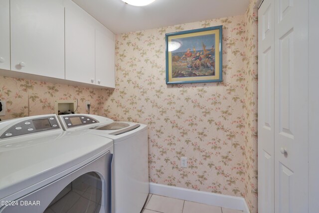 4631 S Atlantic Ave Unit 8101, Ponce Inlet, FL 32127 - laundry room featuring washing machine and clothes dryer, light tile patterned floors, cabinet space, wallpapered walls, and baseboards