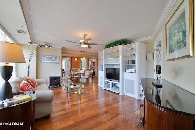 living room with crown molding, ceiling fan, and wood-type flooring