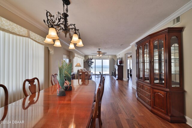 4631 S Atlantic Ave Unit 8101, Ponce Inlet, FL 32127 - dining area with ornamental molding, dark wood-type flooring, baseboards, and a ceiling fan