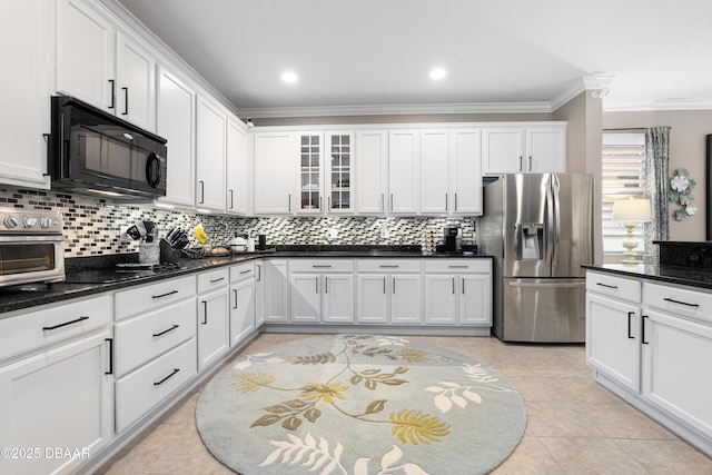 kitchen featuring white cabinets, dark stone countertops, and black appliances