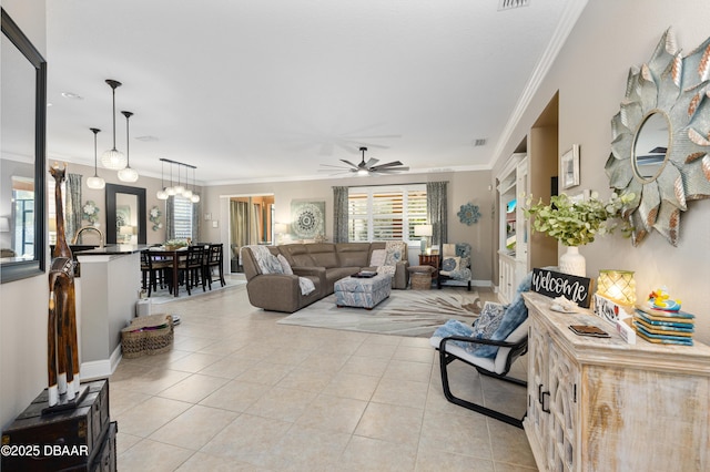 tiled living room with crown molding and ceiling fan