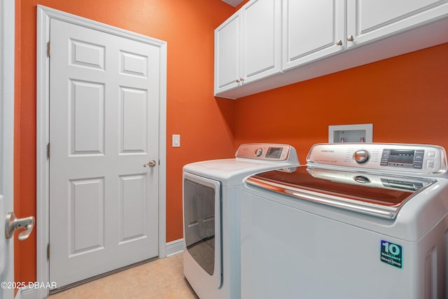 laundry room featuring cabinets, washing machine and clothes dryer, and light tile patterned floors